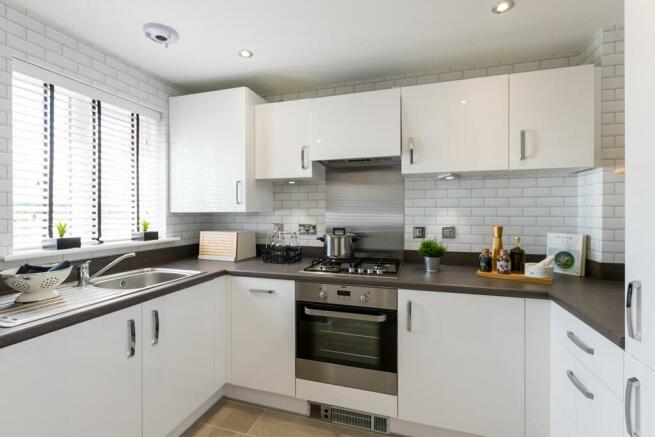 Large windows flood the kitchen with natural light