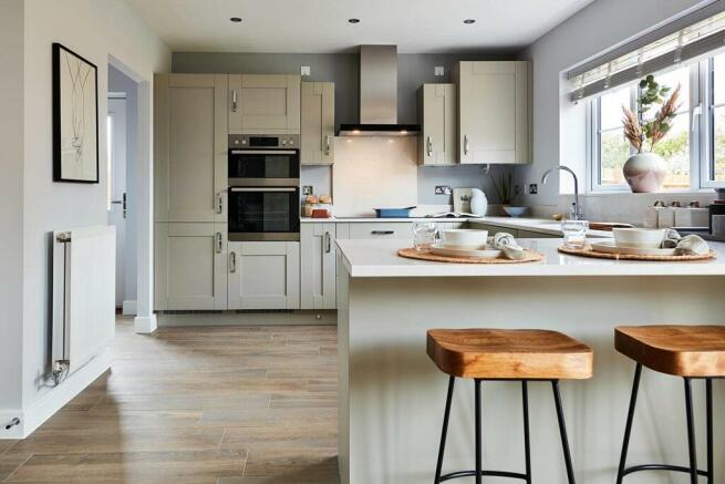 The kitchen features a breakfast bar, creating a sociable space for the family