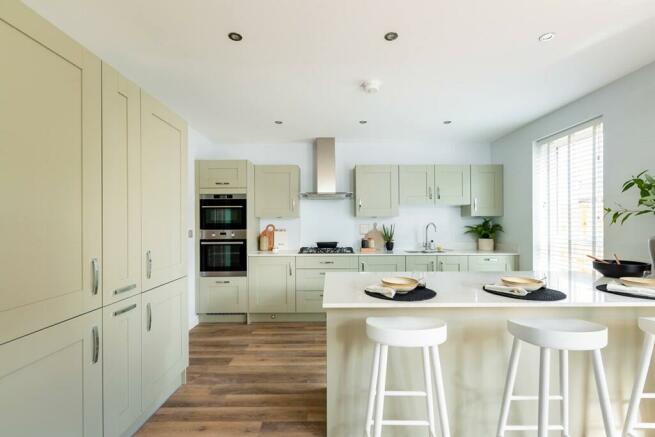 The modern kitchen/diner with doors out to the garden