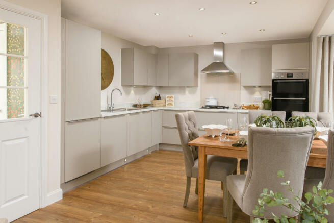 Open-plan kitchen with integrated appliances, dining area & family room with French doors leading on