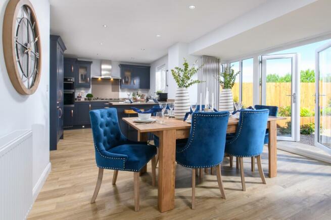 Open-plan kitchen/diner with glazed bay leading to garden in Bradgate style home