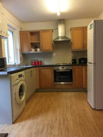 Bright fitted kitchen with ample storage, integ...