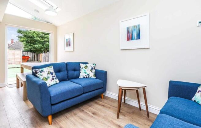 Bright, modern living room with comfortable blu...