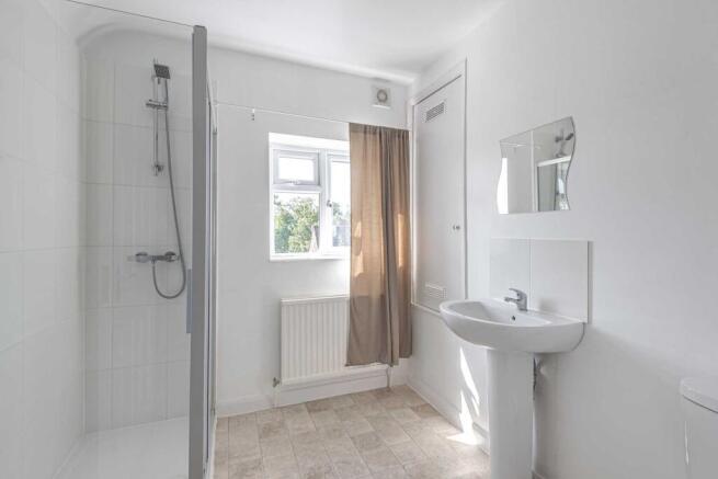 Bright, modern bathroom with a walk-in shower, ...
