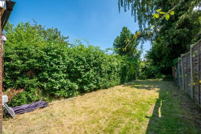Private sunny rear garden with a well-kept lawn...