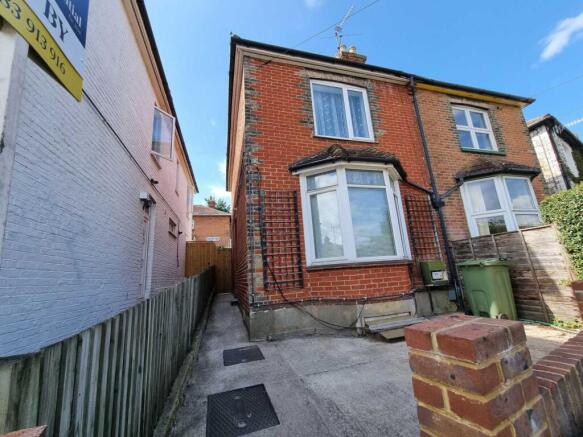 Brick-front semi-detached house with a bay wind...