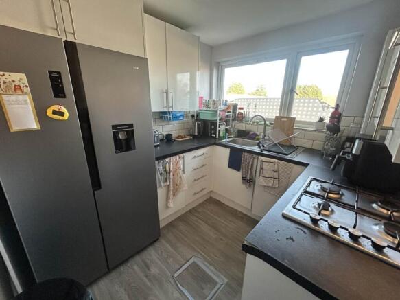 Bright, modern kitchen with L-shaped worktops, ...