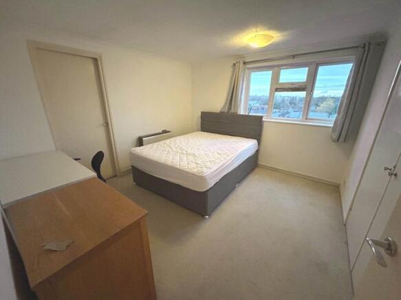Bright, simply furnished double bedroom with a ...