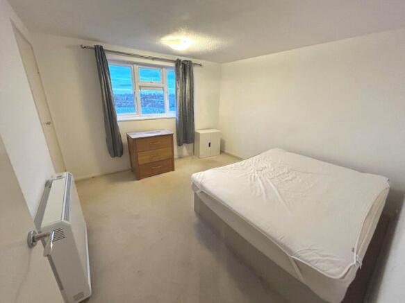 Bright, simply furnished double bedroom with a ...