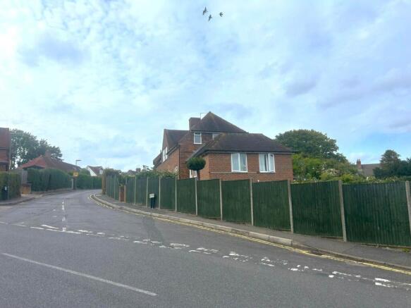 Well-maintained detached brick house set back b...