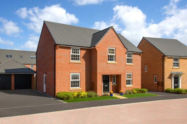 outside view of detached home with a double garage and parking for four cars