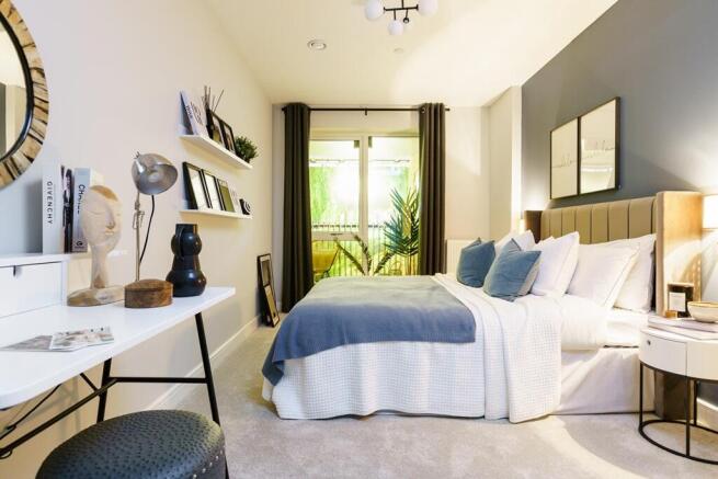 Large bedroom with double doors onto a private balcony