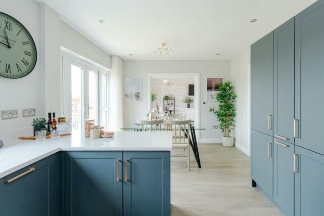 The kitchen/breakfast room leads through double doors to the living room