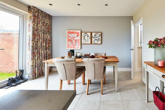 The dining area has double doors out to the garden, flooding the room with natural light