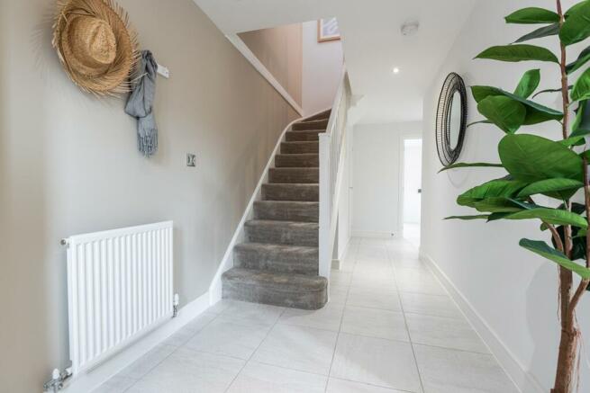 Bright and spacious hallway with under stairs storage