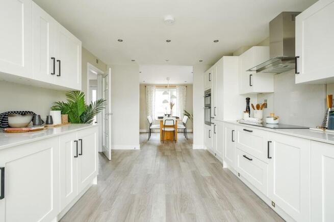 The kitchen leads through to the dining area, perfect for family mealtimes