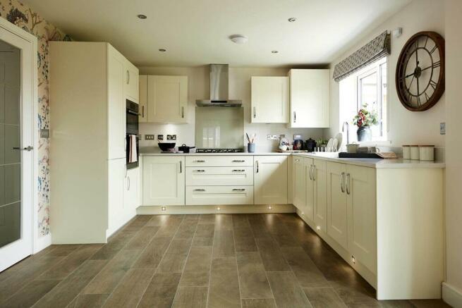 A spacious kitchen is perfect for entertaining and features an adjoining utility area