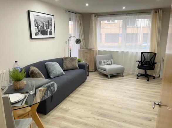 A spacious and inviting modern living room fill...