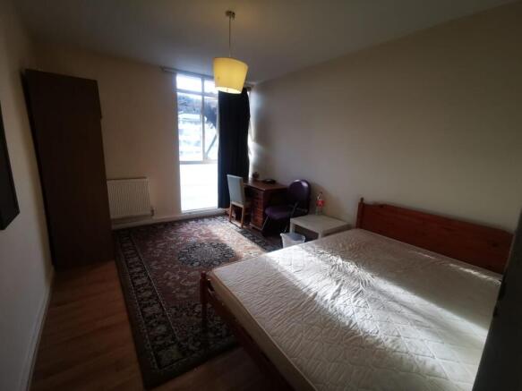 A bright and tidy double bedroom featuring a co...