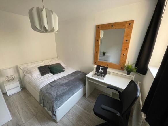 A bright and inviting double bedroom featuring ...