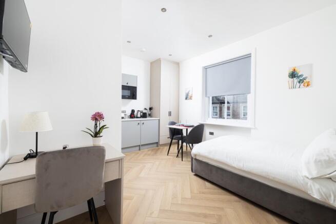 Bright and modern double bedroom featuring a co...
