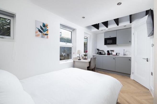 This charming double bedroom features a cozy at...