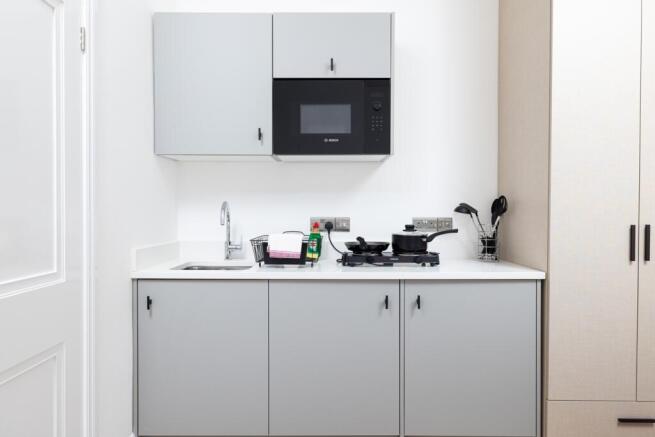A modern and well-equipped kitchen featuring sl...