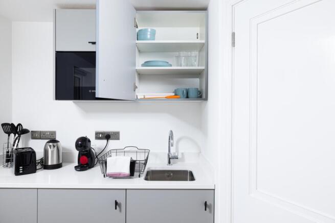 Modern kitchen featuring sleek cabinetry and am...