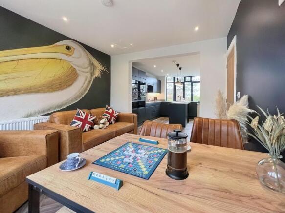 A stylish living room featuring warm brown leat...