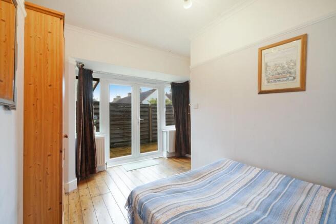 Bright and cozy double bedroom featuring polish...