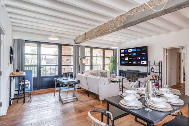 Spacious and inviting living room featuring mod...
