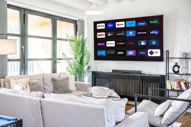 A stylish and contemporary living room featurin...