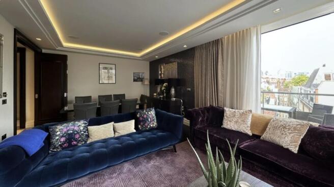 A stylish contemporary living room featuring pl...