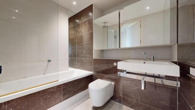 Modern bathroom suite featuring a sleek bathtub...