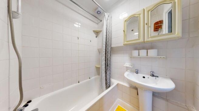 Bright and clean bathroom featuring a classic w...