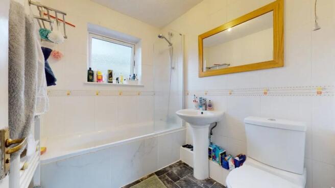 Bright bathroom suite featuring a clean, modern...