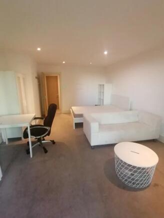 A spacious and neatly arranged master bedroom f...