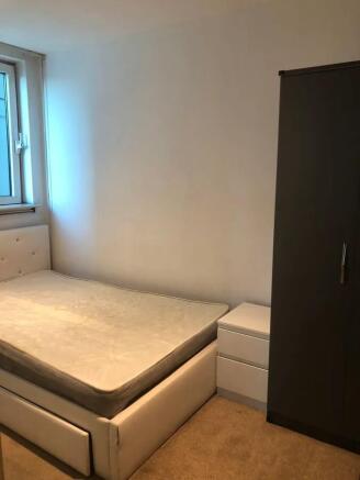 A cozy double bedroom featuring a comfortable u...