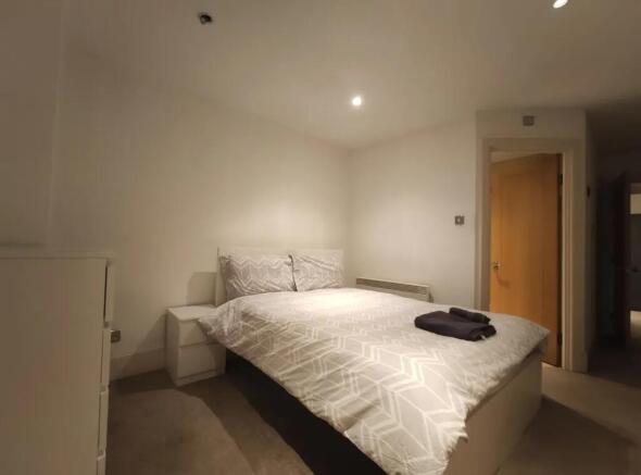 A neat and simple double bedroom featuring a we...