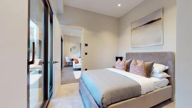 A stylish and spacious master bedroom featuring...