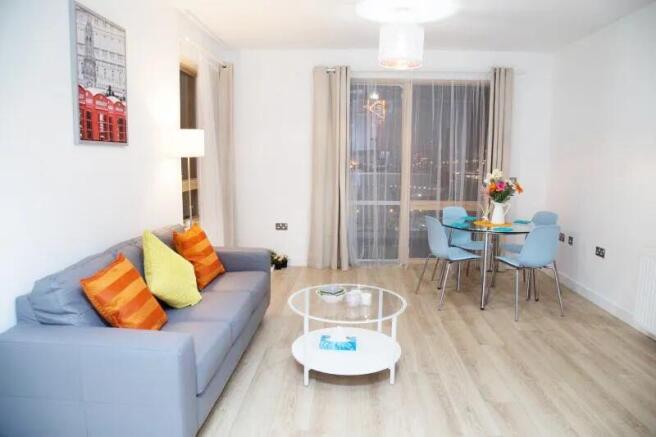 A modern living room featuring a comfortable gr...