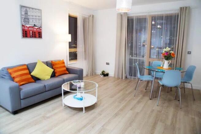 Bright and modern living room featuring a comfo...