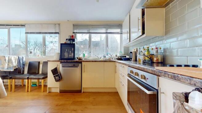 Bright and airy kitchen featuring large windows...