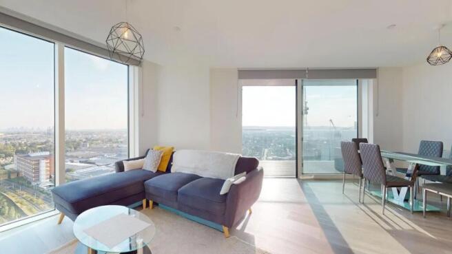 Bright and spacious living room with floor-to-c...