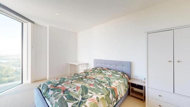 Bright and spacious master bedroom featuring a ...