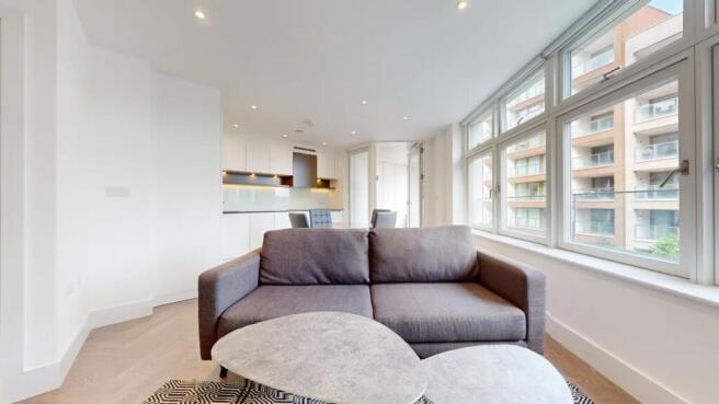 Bright and modern living room featuring a large...