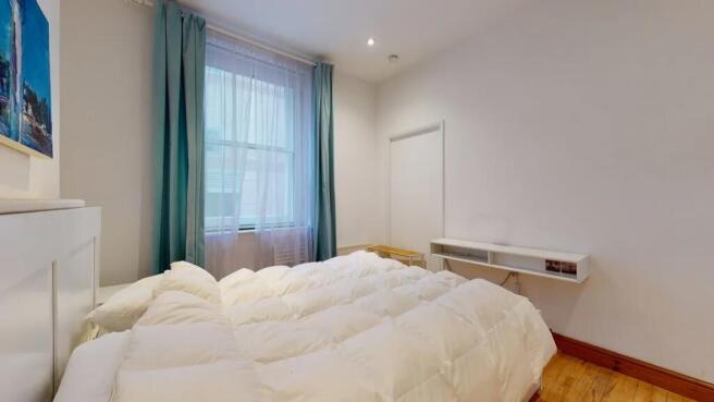 A bright and clean master bedroom featuring a l...