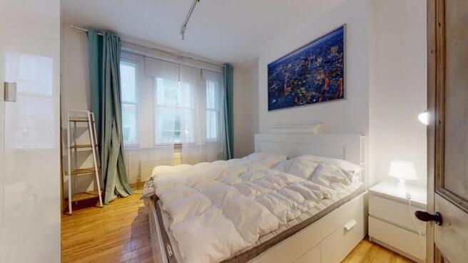 Bright and inviting double bedroom featuring a ...