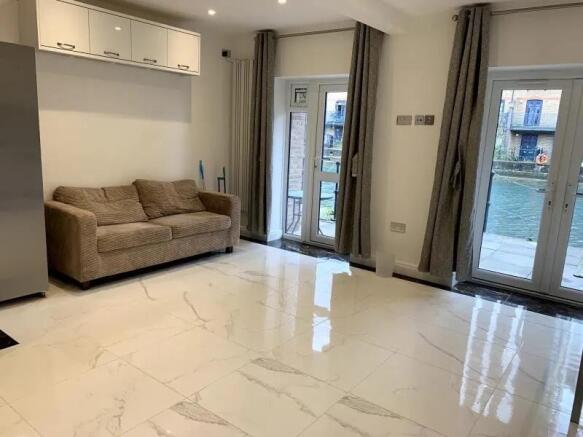 Bright and modern living room featuring glossy ...