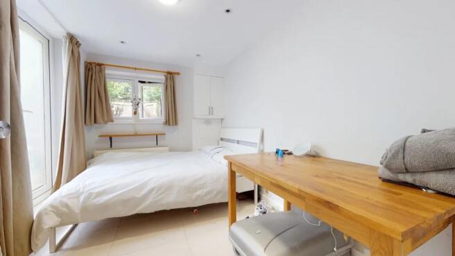 Bright and tidy double bedroom featuring a comf...